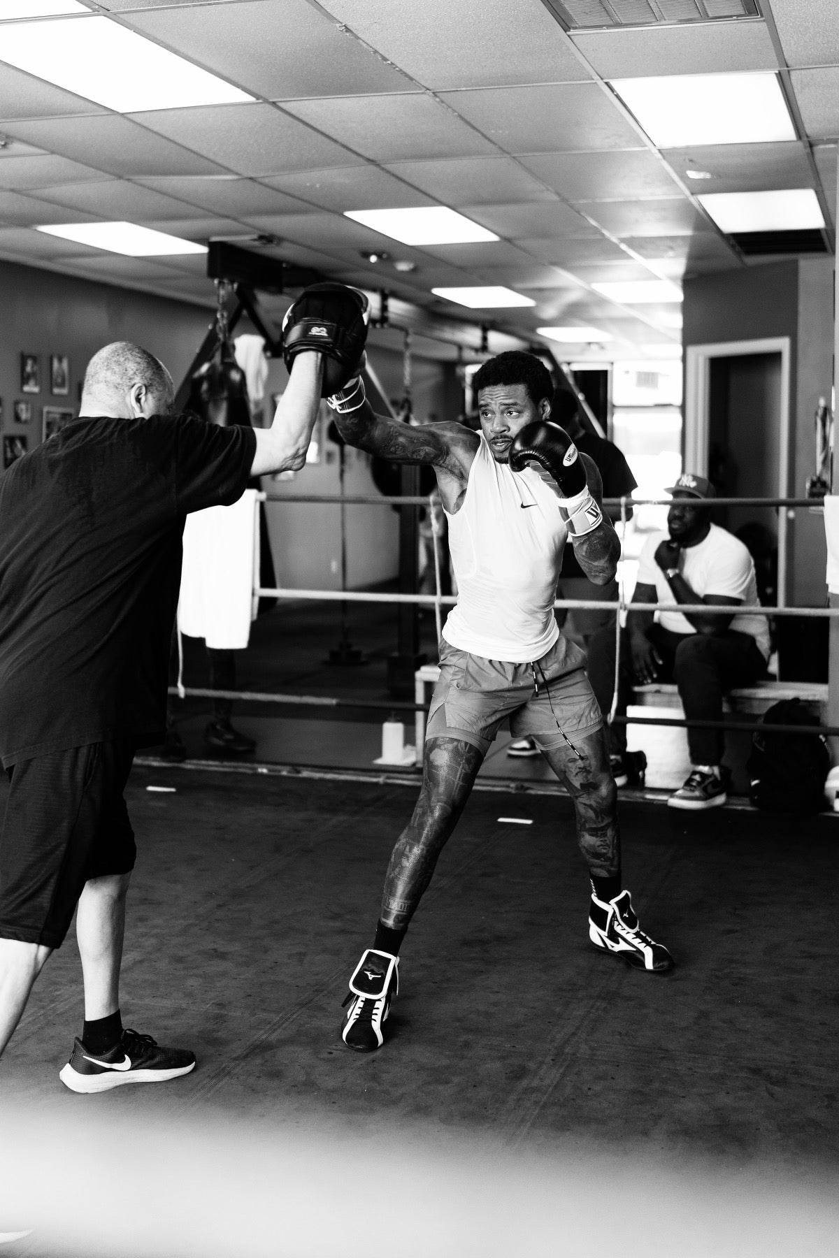 Errol Spence Jr. throwing a punch during training with a coach